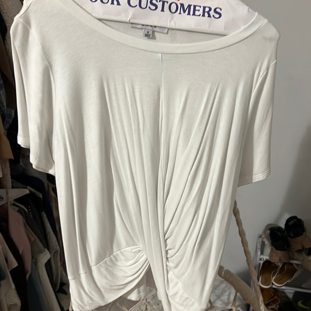 White shirt what crosses in the front. It is a long shirt.